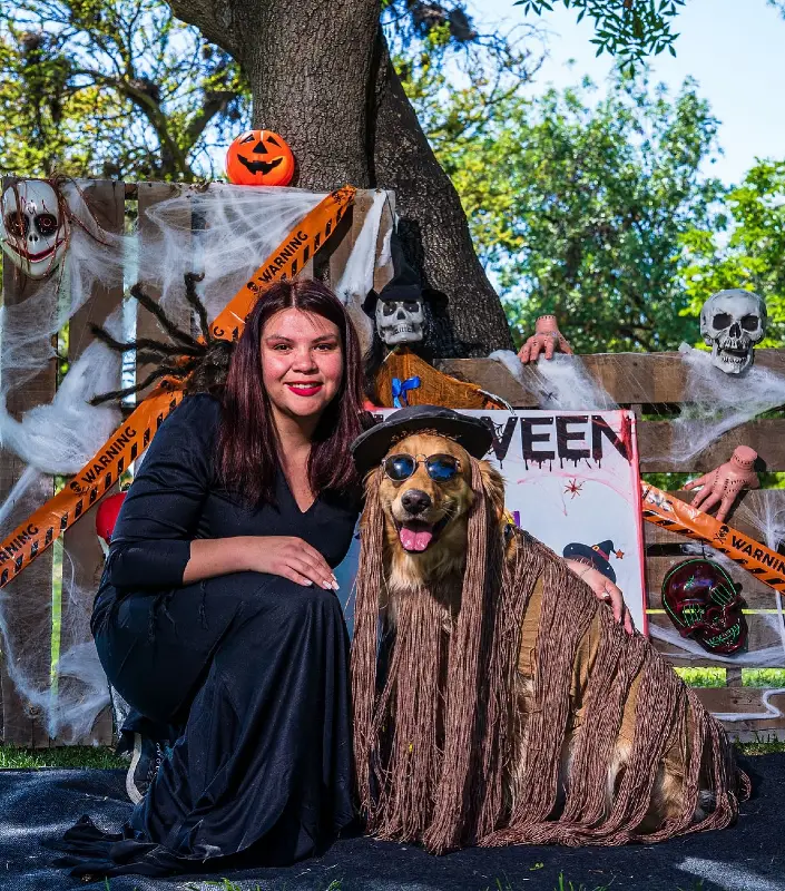 1. Fringed Boho Witch Costume on a Golden Retriever with Halloween Props