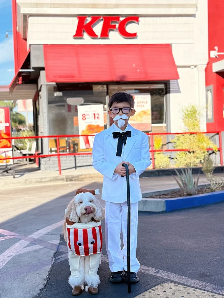 11. Vintage Butler and Popcorn Dog Duo Costume Outside Fast Food Spot with KFC Backdrop