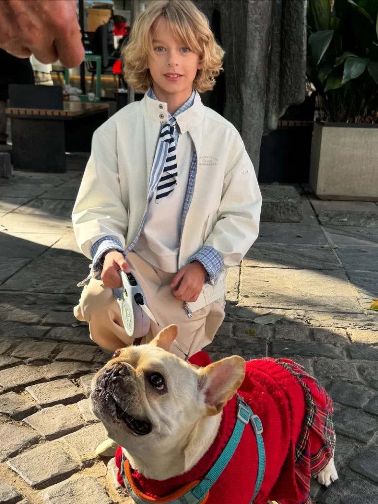 12. Smart Casual Preppy Outfit with Blazer Jacket Boy and French Bulldog in Red Knit Costume on Stone Patio