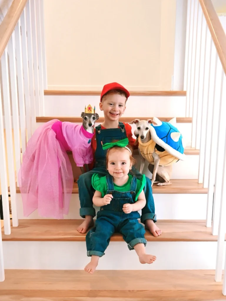 19. Mario-Inspired Sibling and Multi-Dog Character Costume Scene on Indoor Stairs