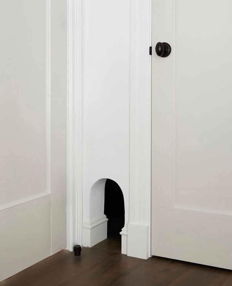 Built-In Arched Wall Pass-Through with Wrapped Baseboard Molding