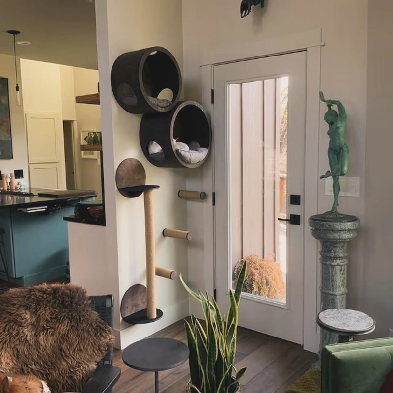 Circular Dark Wood Cat Caves with Sisal Scratching Pillars beside a Glass Door