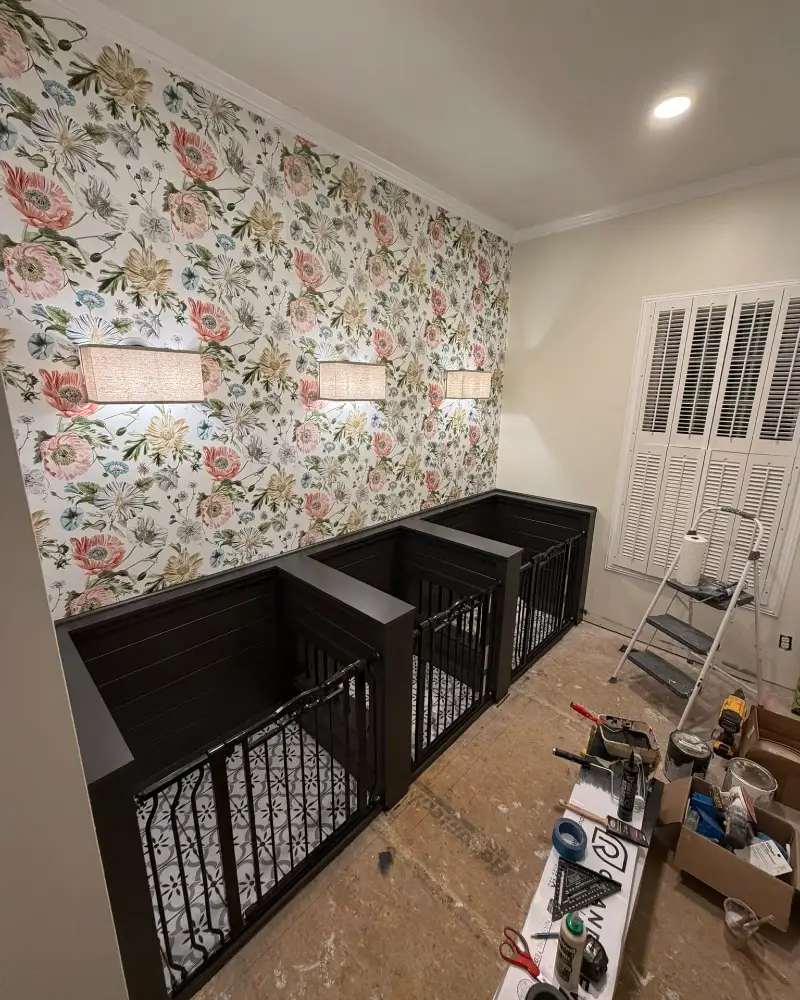 Custom Charcoal Dog Kennels in Progress with Raw Subfloor and Renovation Gear