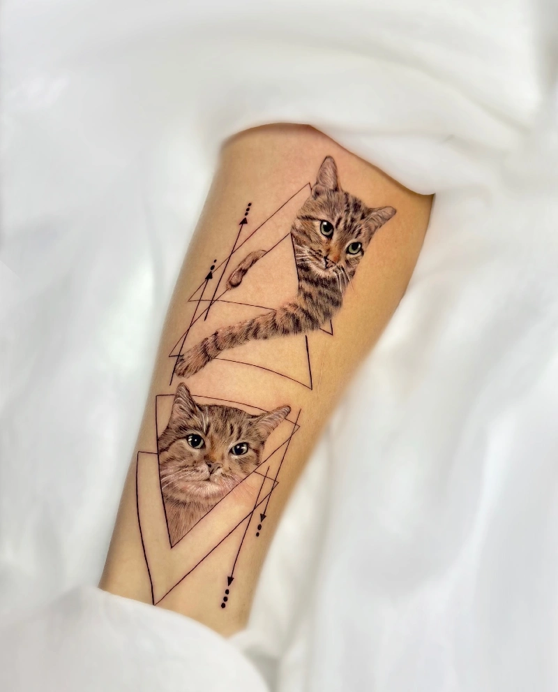 Geometric Abstract Dual Tabby Cat Portrait Tattoo on the Inner Forearm