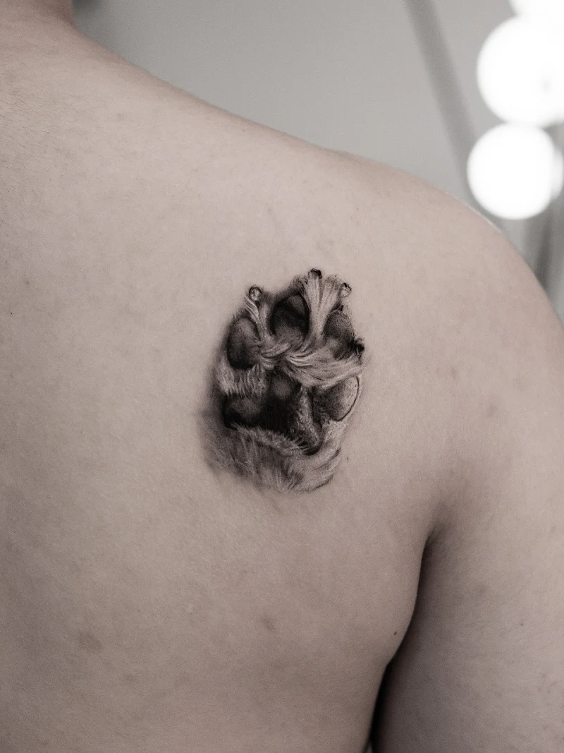 Hyper-Realistic Furry Dog Paw on Upper Back