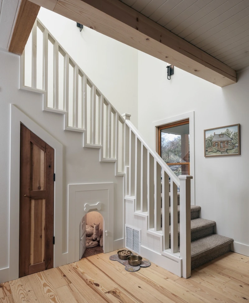 Integrated Under-Stair Alcove with Bone Silhouette Cutout and Custom Wooden Doors