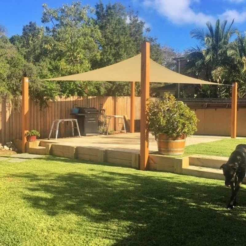 Large Beige Shade Sail Anchored by Heavy Timber Posts