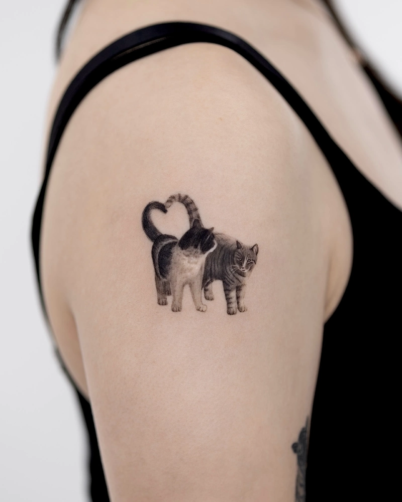 Micro-Realism Dual Cat Tattoo with Heart-Shaped Tails on the Upper Arm