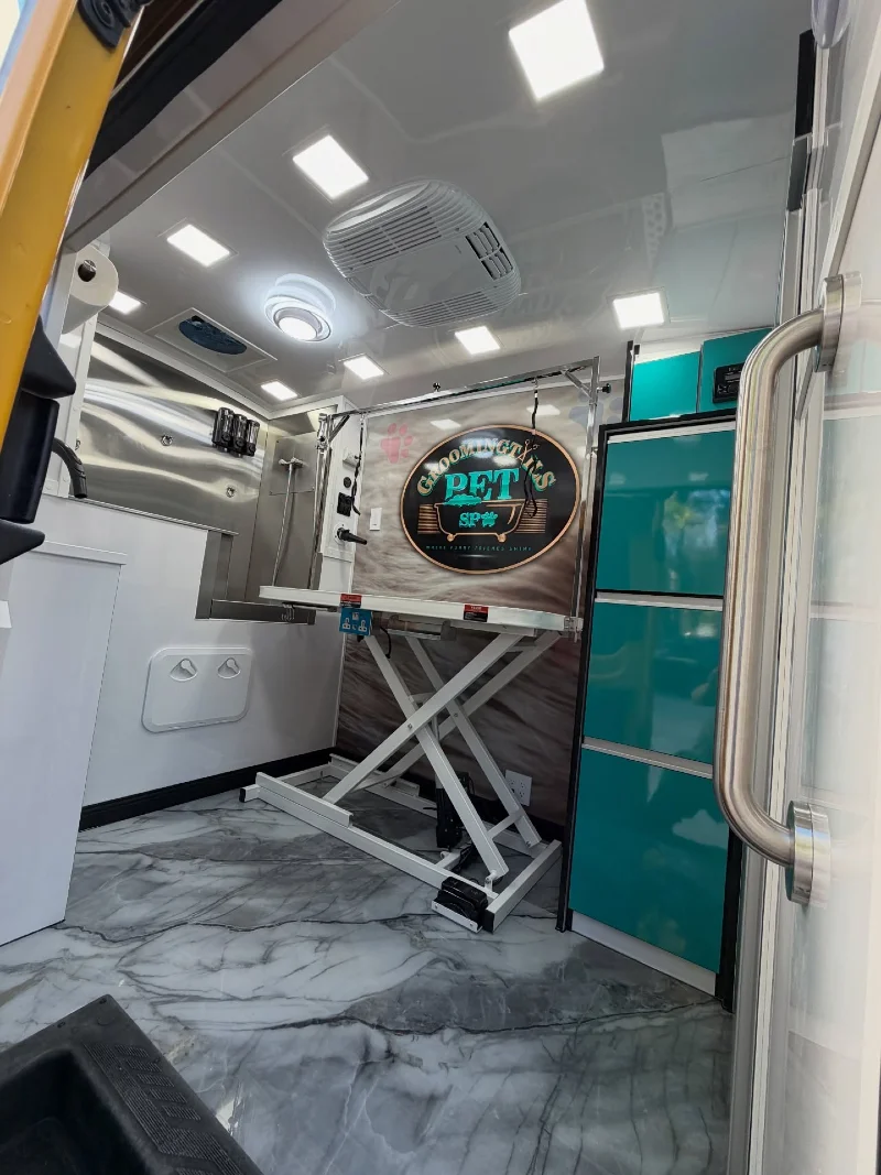 Modern Teal Cabinetry with White Scissor-Lift Table and Gray Swirled Marble Flooring