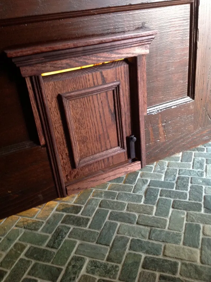 Raised-Panel Dark Oak Pet Entry with Classical Cap Trim Casing