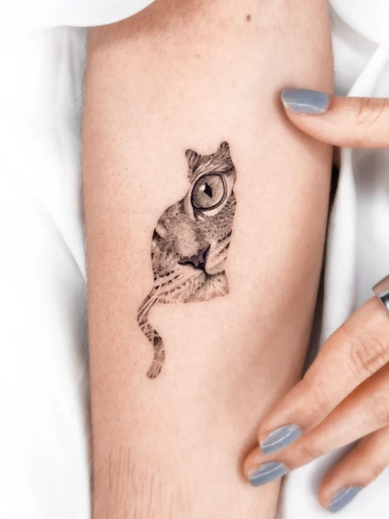 Realistic Double-Exposure Cat Face Silhouette Tattoo on the Forearm