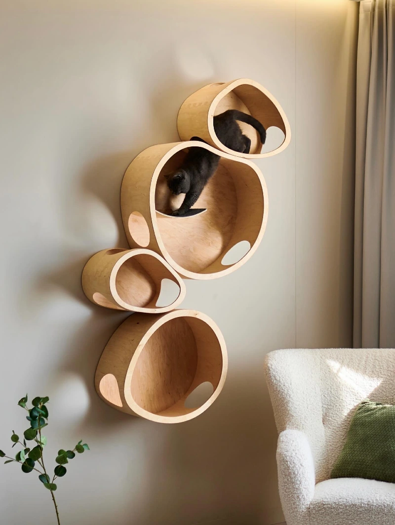 Sculptural Organic Bentwood Cat Pods arranged vertically near a BouclΓ© Armchair