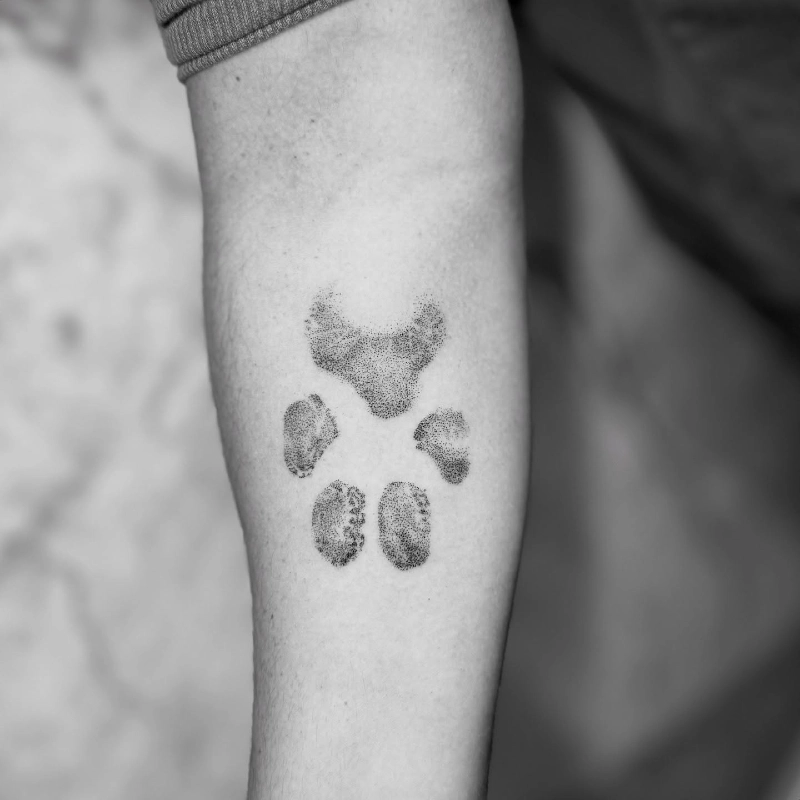 Soft Dotwork Minimalist Paw Print Tattoo on Forearm