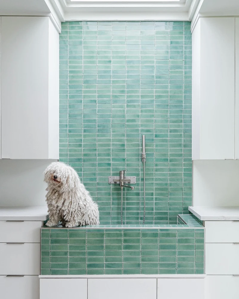 Vertically Stacked Mint Green Linear Tile Station with White Cabinetry