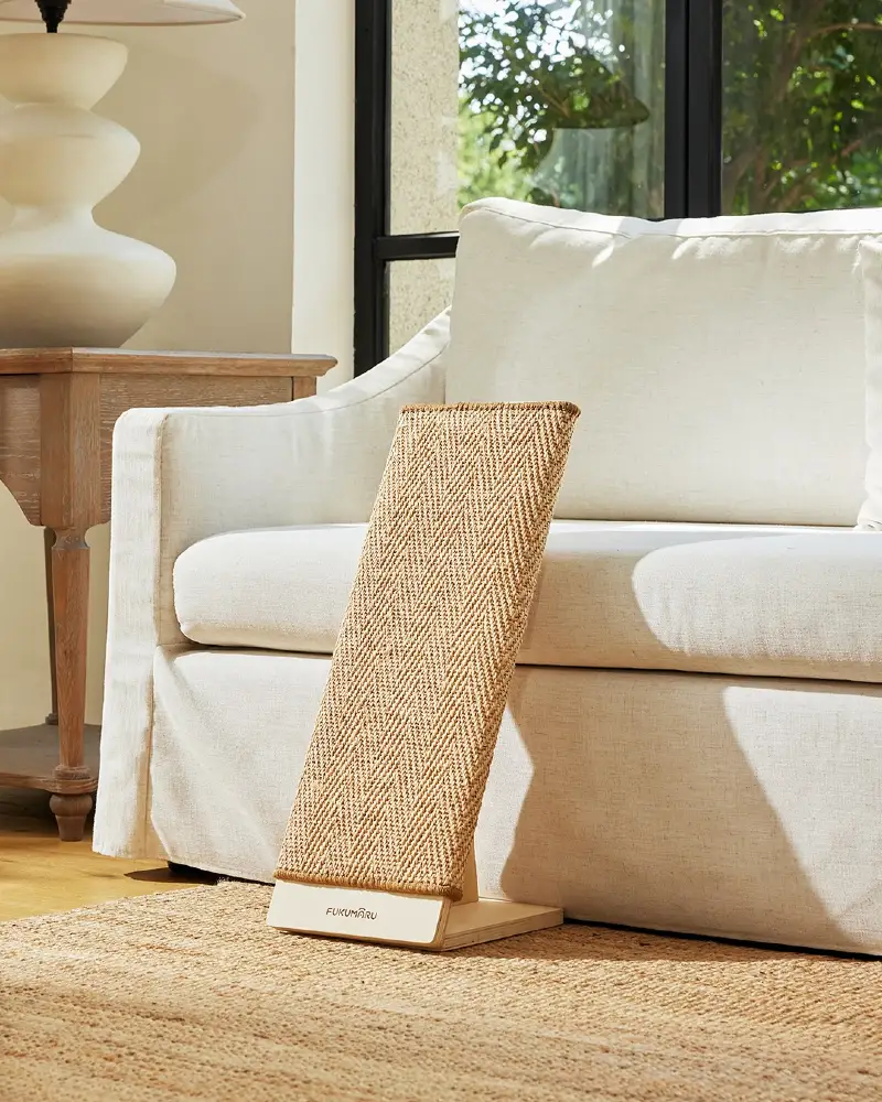 Angled Woven Herringbone Scratching Board Leaning Against Cream Slipcovered Sofa