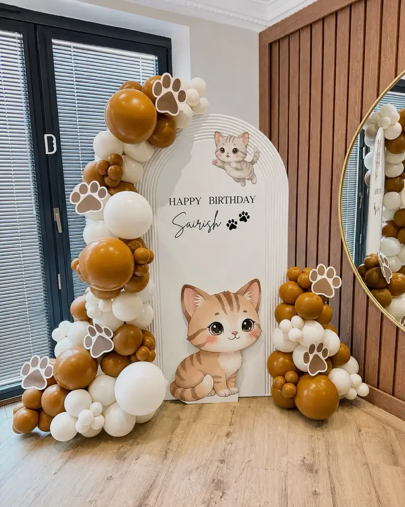 Arched Ribbed Backdrop with Toffee Balloon Garland and Cartoon Cat Cutouts