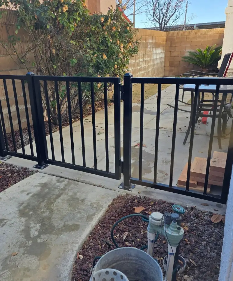 Black Aluminum Picket Fence with Surface-Mount Base Plates on Concrete Patio