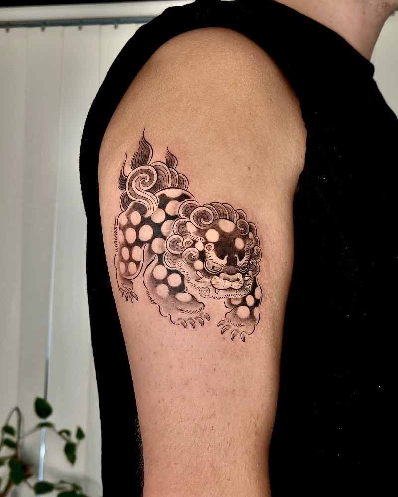Black and Grey Spotted Foo Dog Upper Arm Tattoo