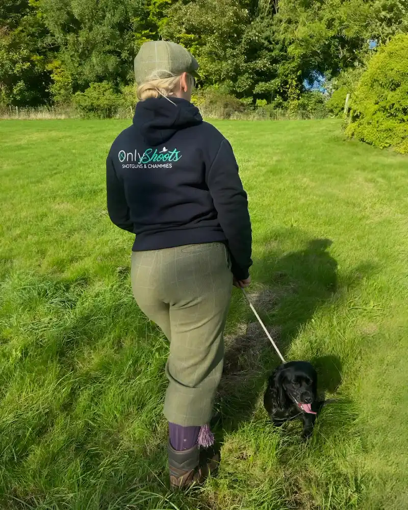 Country Tweed Attire with a Black Cocker Spaniel in an Open Field
