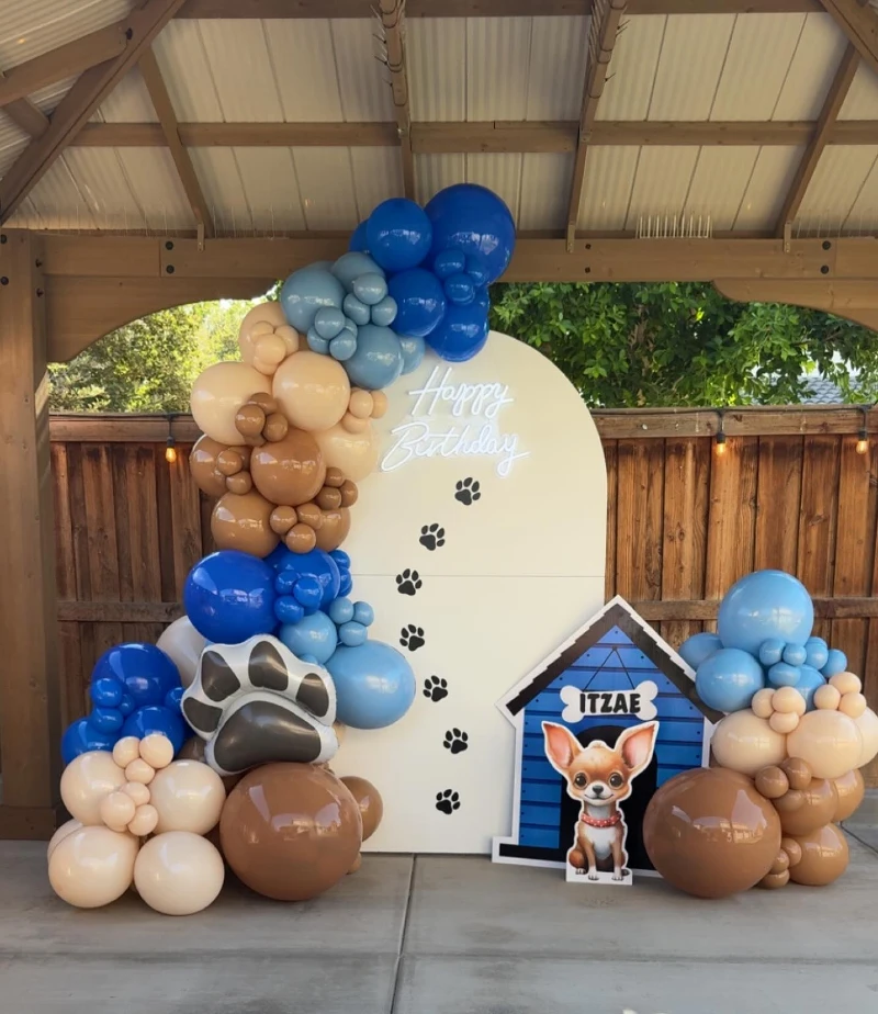 Cream Arch Backdrop with Electric Blue Balloon Installation and Doghouse Character Cutout