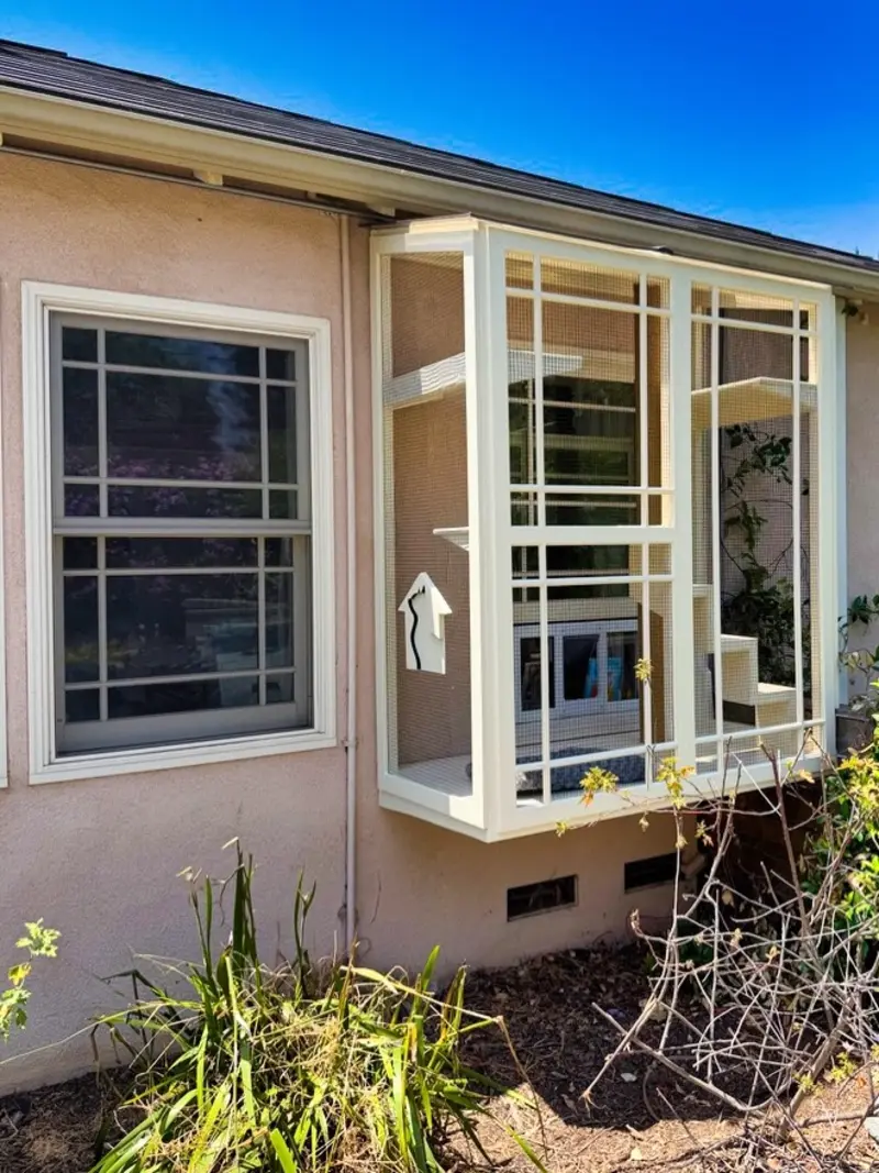 Cream Window-Box Catio with Craftsman-Style Grid Trim and Stepped Corner Perches