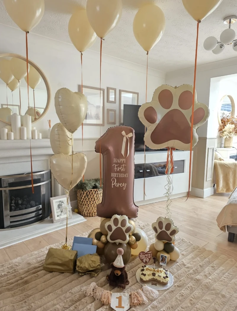 Earth-Toned Balloon Columns with Matte Paw-Print Mylar Shapes and Bone Cake