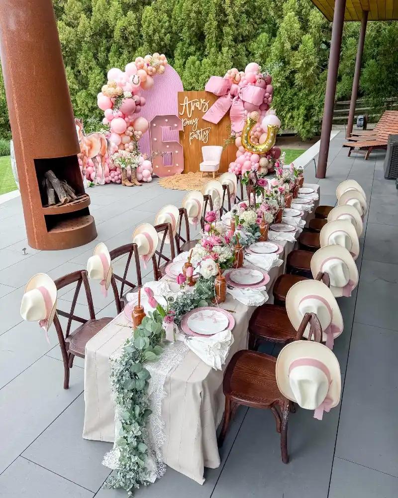 Elegant Long Tablescape with Pink-Ribboned Cowboy Hats and Eucalyptus Runners