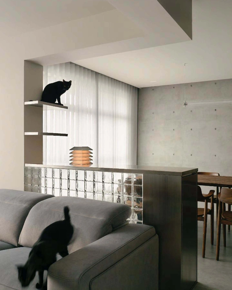 Floating White Corner Ledges Integrated into a Brutalist Space with Glass Blocks and Concrete Walls