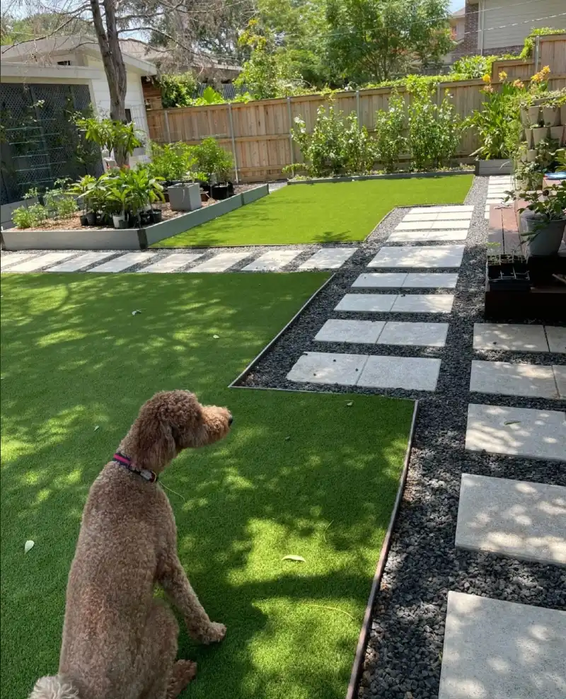 Geometric Paver Pathways with Dark Gravel Inlay and Fenced Synthetic Lawns