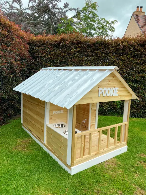 Light Wood Cabin With White Metal Roof