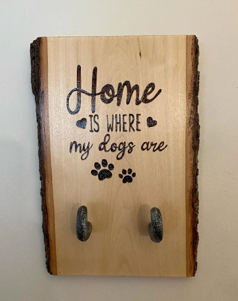 Live-Edge Wood Slab with Pyrography Quote and Distressed Iron Hooks