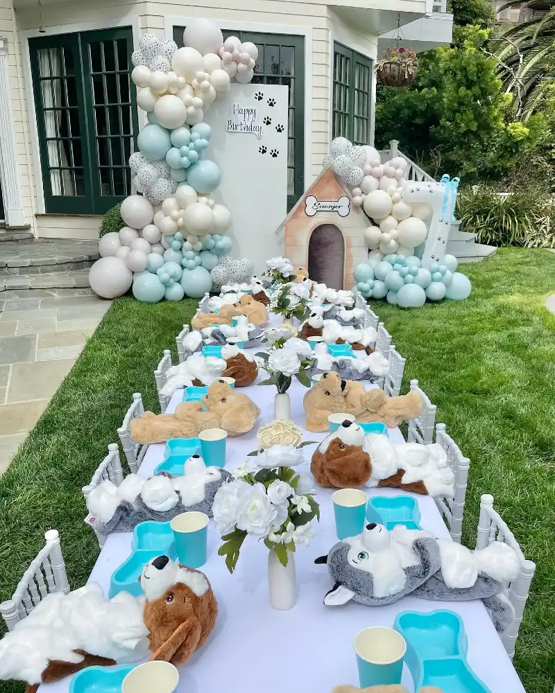 Long Banquet Table with Plush Puppy Centerpieces and Mint Balloon Arch Backdrops