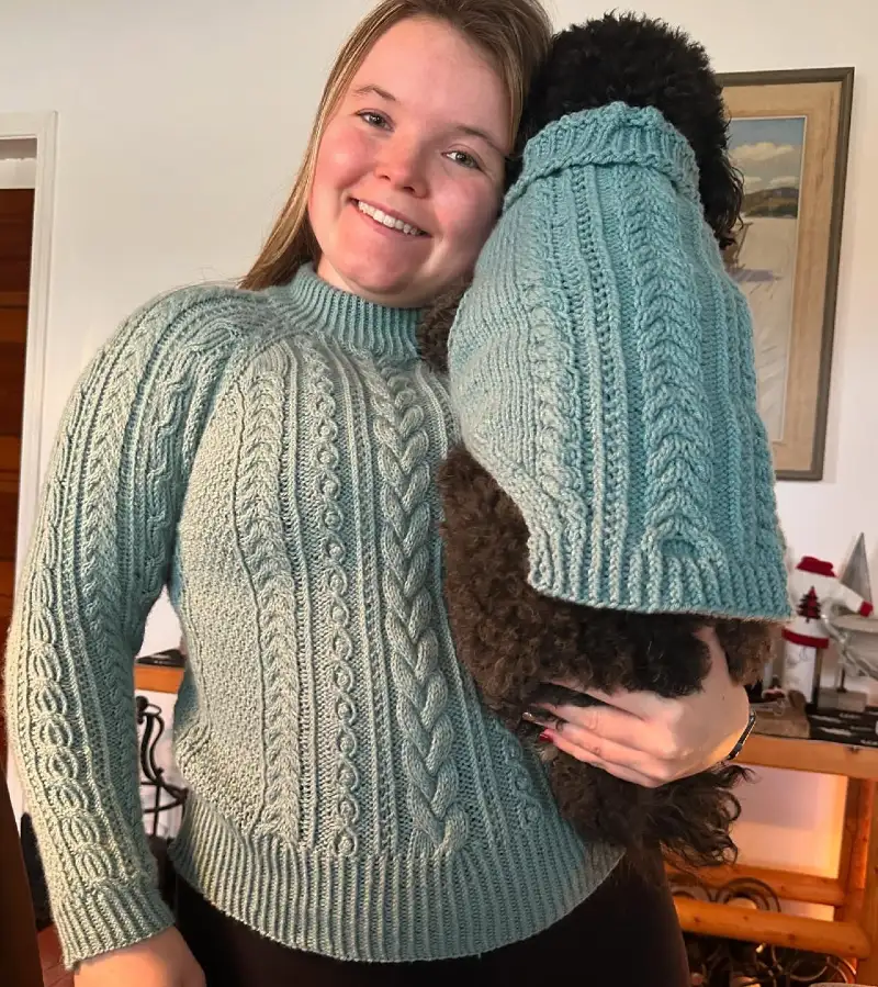 Mint Green Cable Knit Sweaters on a Woman and Her Dark Fluffy Dog
