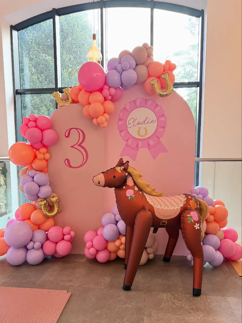 Pastel Arched Backdrop with Floral Foil Horse Balloon and Lavender Accents