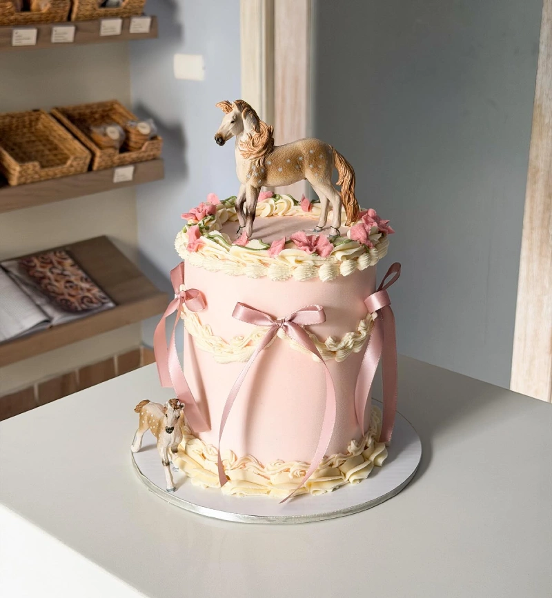 Pastel Lambeth Cake with Satin Bows and Dappled Pony Toppers
