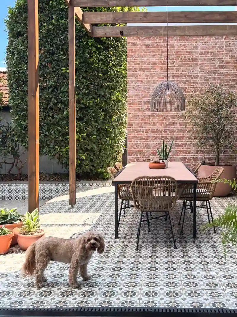 Patterned Tile Patio with Wooden Pergola and Woven Dining Chairs