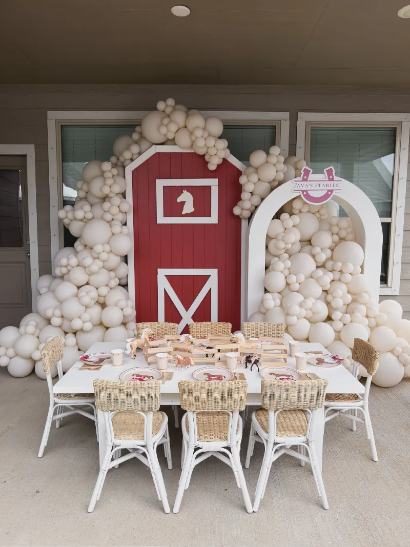 Red Barn Backdrop with White Woven Dining Chairs and Miniature Toy Paddock Centerpiece
