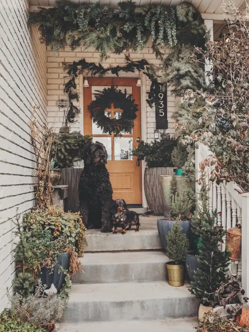 Rustic Front Porch with Pine Garlands, Wreath, and Potted Evergreens