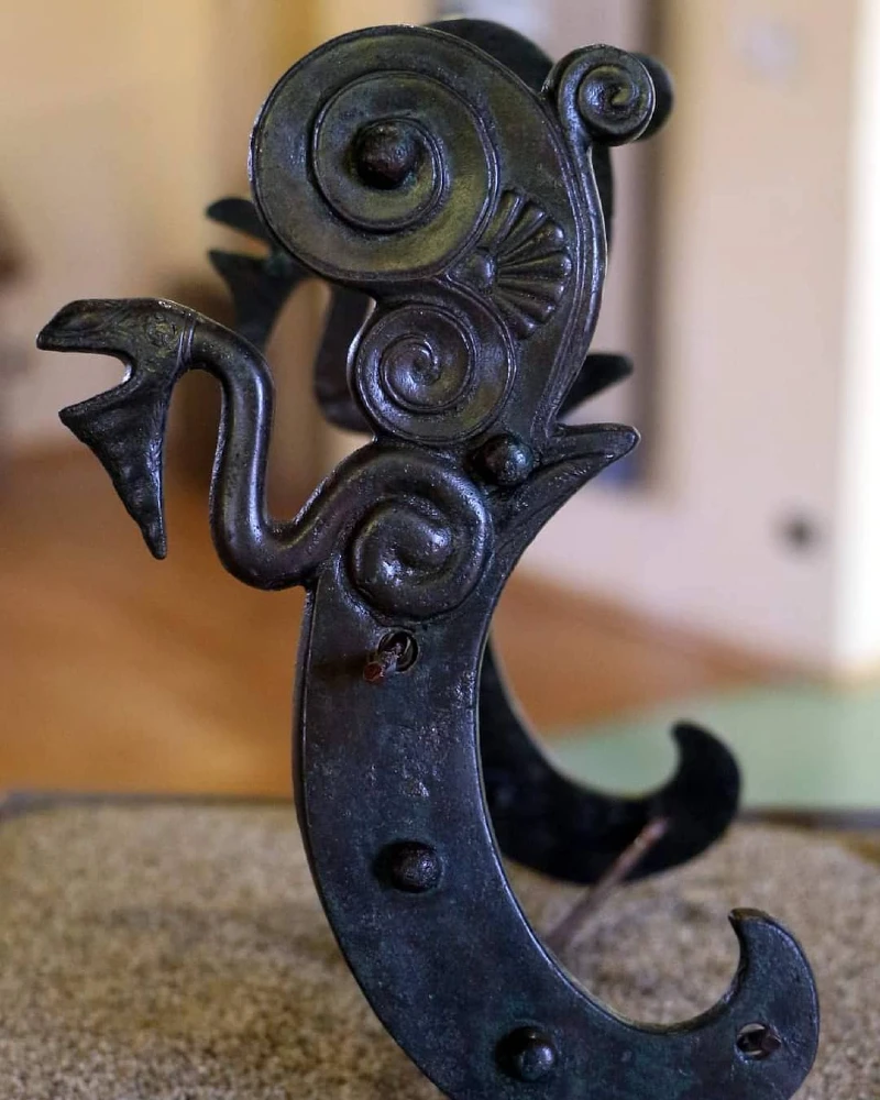 Sculpted Bronze Cheekpiece with Serpent Motif and Volute Scrollwork