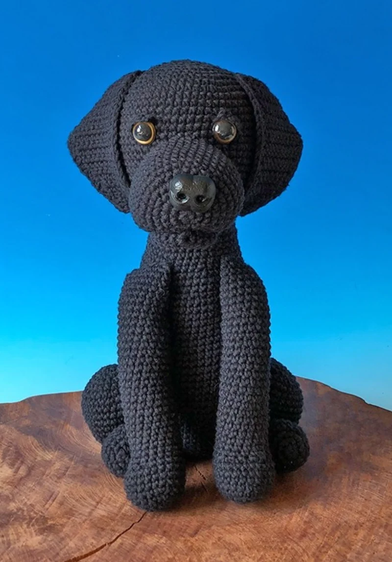 Sleek Black Labrador Figure on Rustic Sliced Wood Slab
