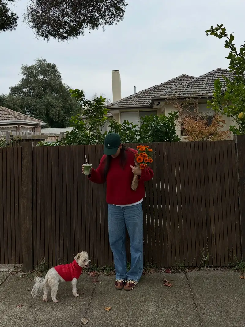 Solid Crimson Ribbed Sweaters on a Woman and Her Small White Terrier Mix