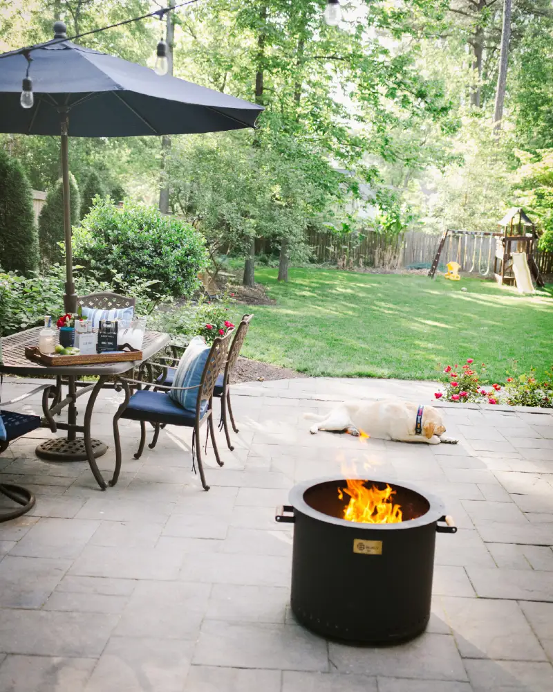 Stone Paver Patio with Smokeless Fire Pit and Dining Set Under Umbrella