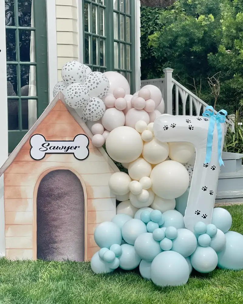 Watercolor Doghouse Cutout with Number Balloon and Pastel Clusters on Lawn