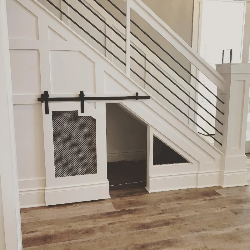 White Board-and-Batten Wall Panel with Sliding Mesh Barn Door and Horizontal Metal Railing