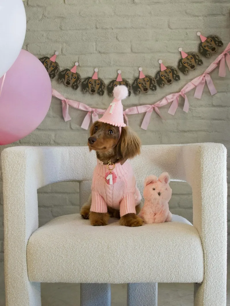 White Bouclé Accent Chair with Pink Cable-Knit Sweater and Custom Garland