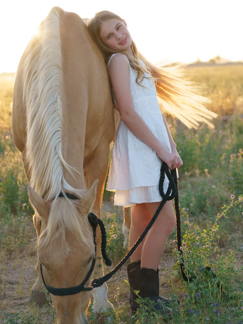 White Mini Dress and Dark Cowboy Boots with a Grazing Palomino