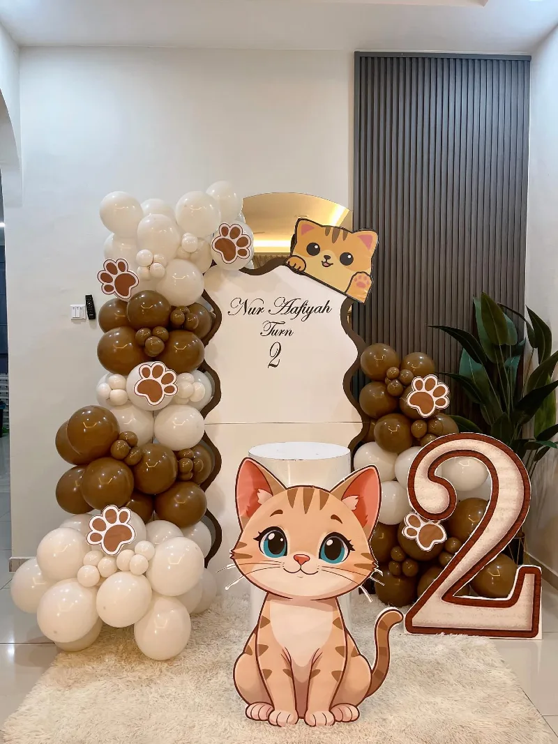 White Wavy Arch Backdrop with Chocolate Balloon Stacks and Large Tabby Cat Cutout