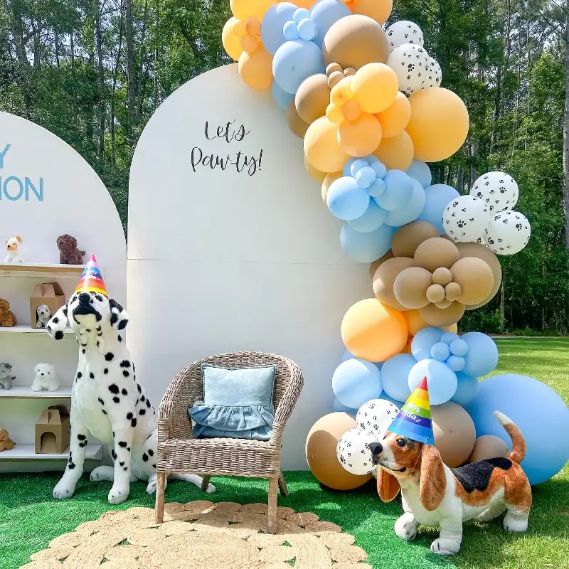 Woven Rattan Armchair with Lifelike Plush Hounds and Sun-Drenched Balloon Cascade