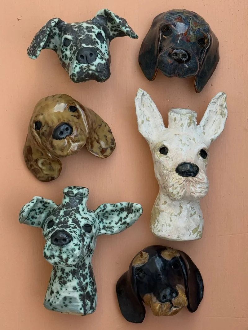 Assorted Ceramic Dog Head Wall Vases on Peach Background