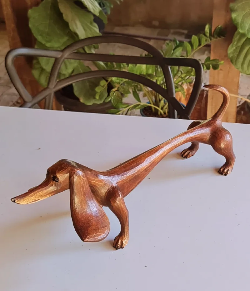 Hand-Carved Wooden Dachshund Figurine on White Tabletop